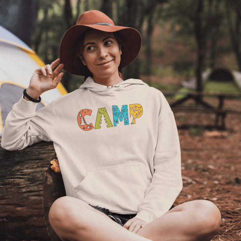 Introducing our vibrant and adventurous camping hoodie! Featuring bold and colorful "Camp" letters adorned with charming camping icons cut out, this shirt is perfect for outdoor enthusiasts and nature lovers alike.